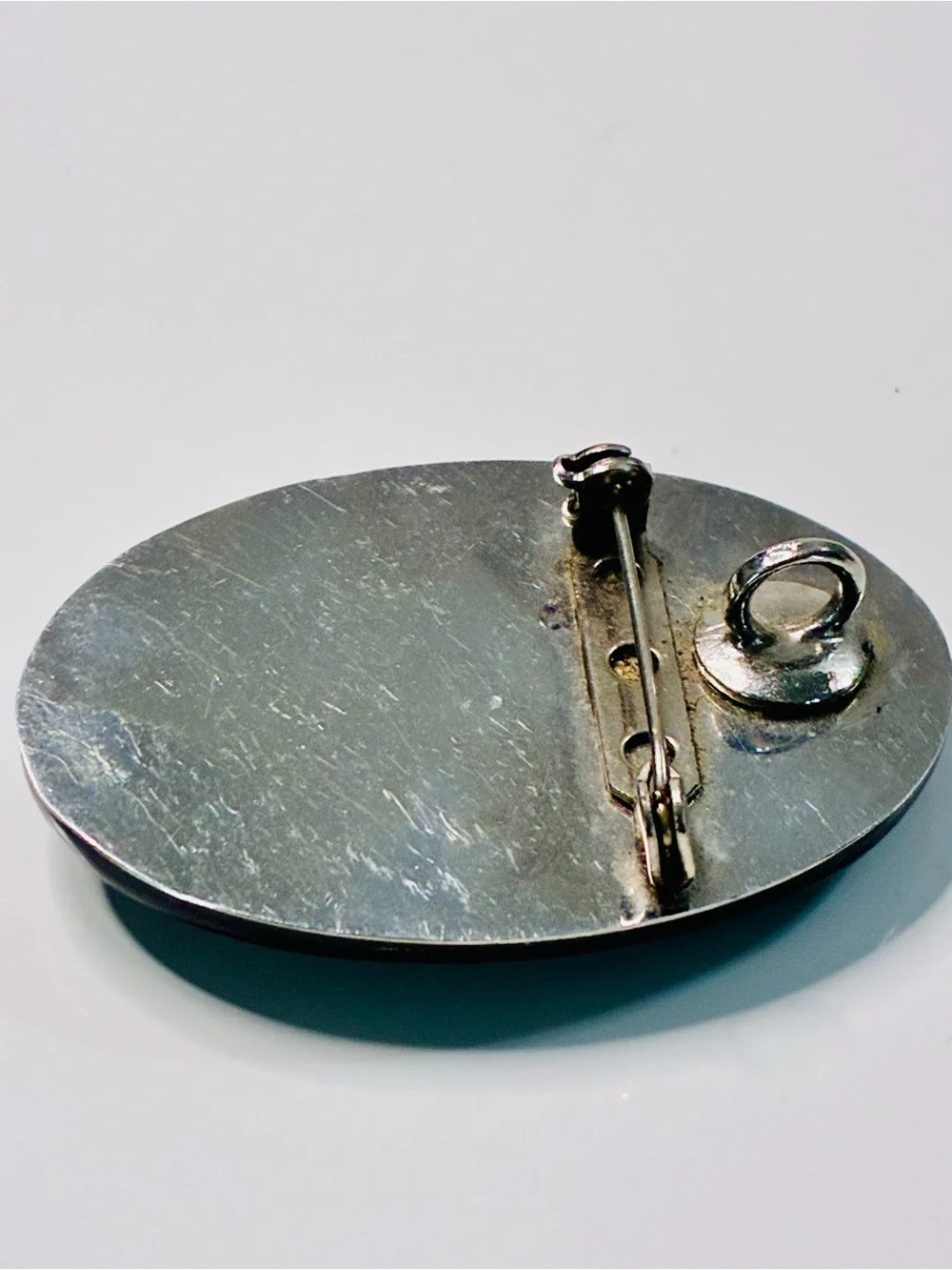 Elevated Simple Black and Silver Oval Brooch with Mother-of-Pearl Center Pendant